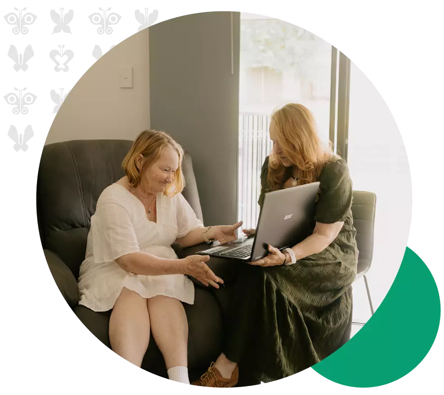 Support assisting an woman using a laptop at home